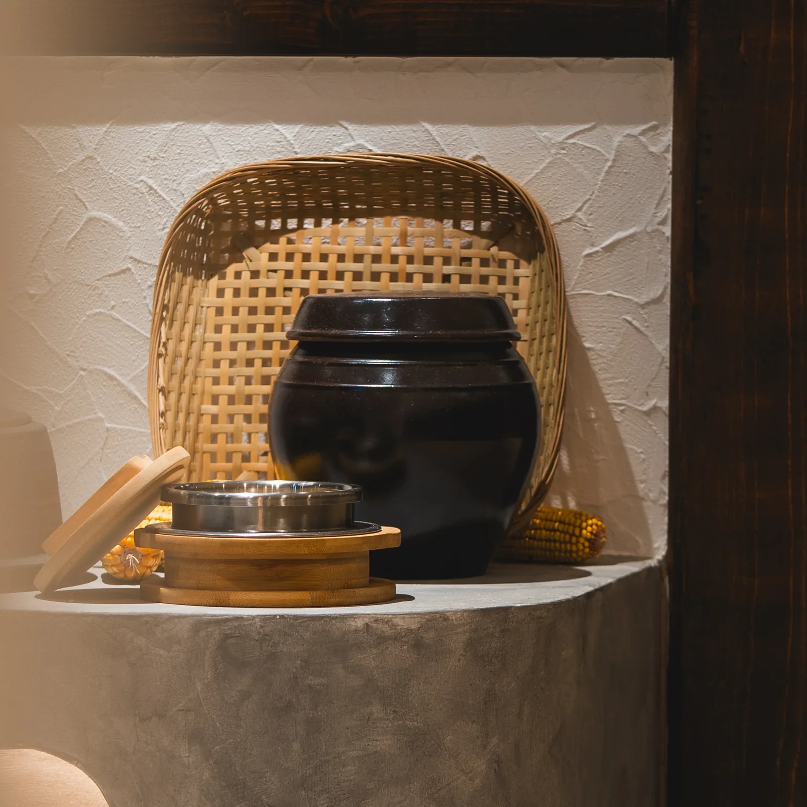 Traditional Korean cooking pots displayed in a softly lit alcove at Sagye